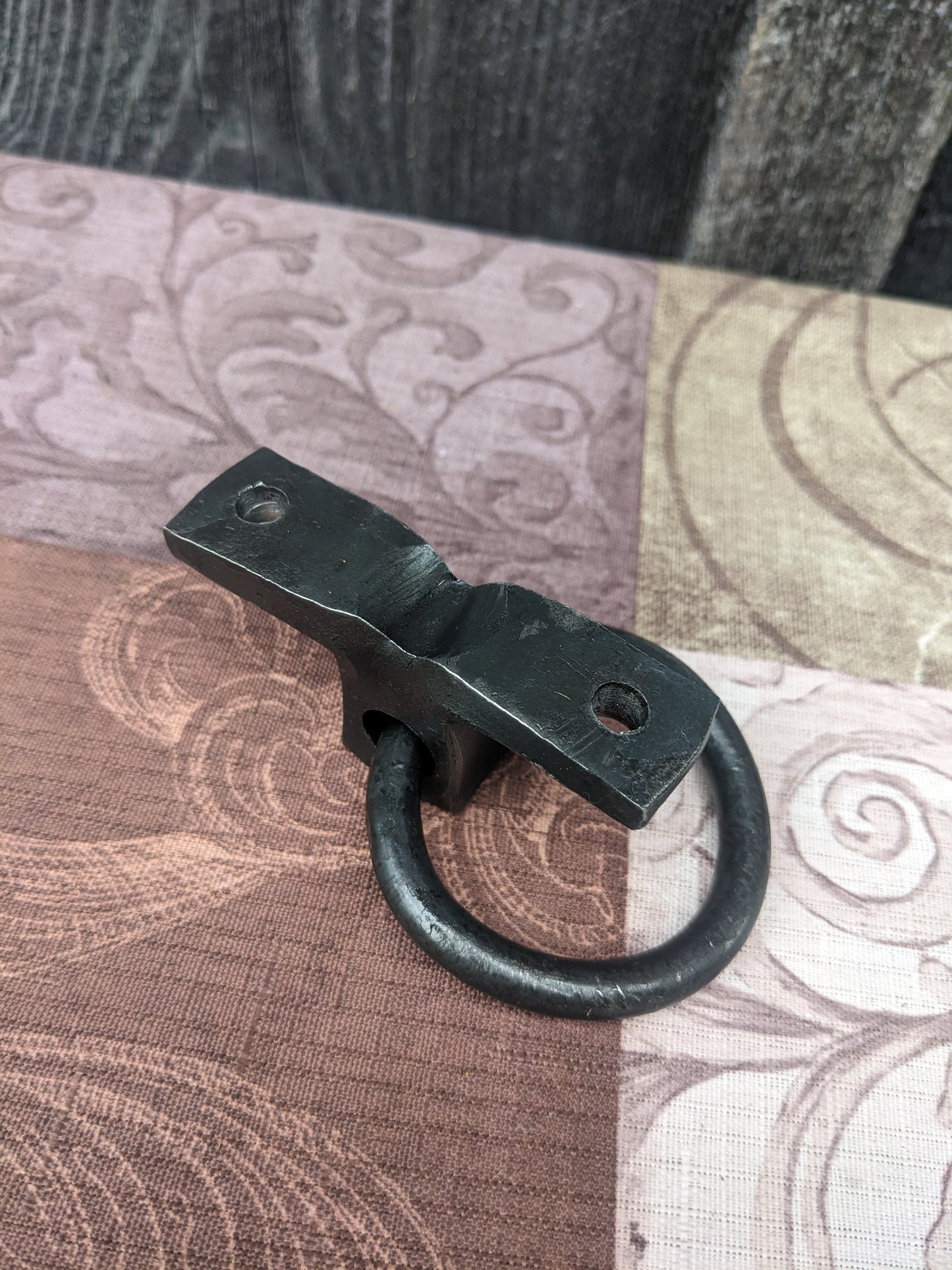 The backside of our hand forged ring bracket. it shows how it is made of one solid piece of steel for extra strength.
