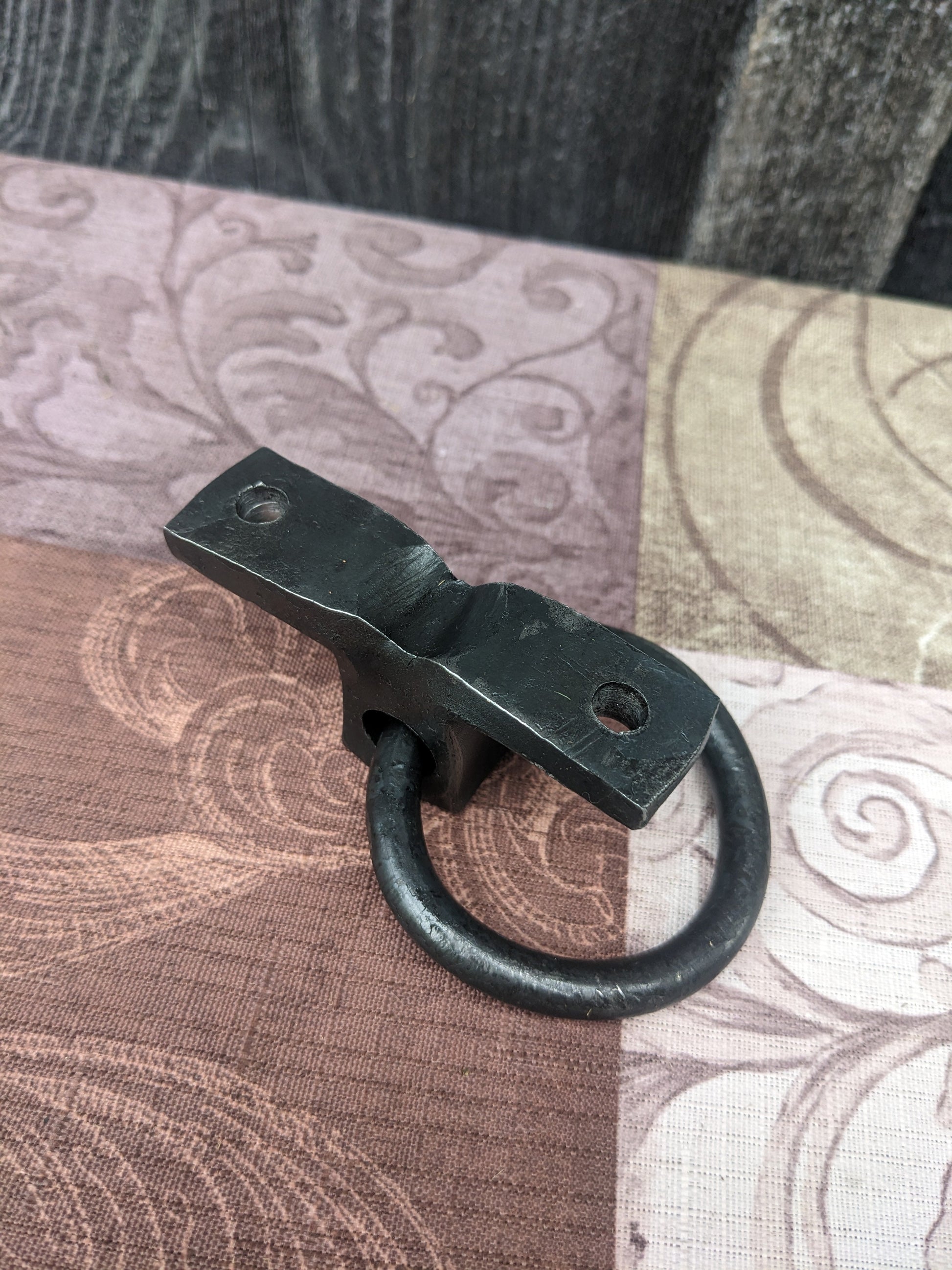 The backside of our hand forged ring bracket. it shows how it is made of one solid piece of steel for extra strength.