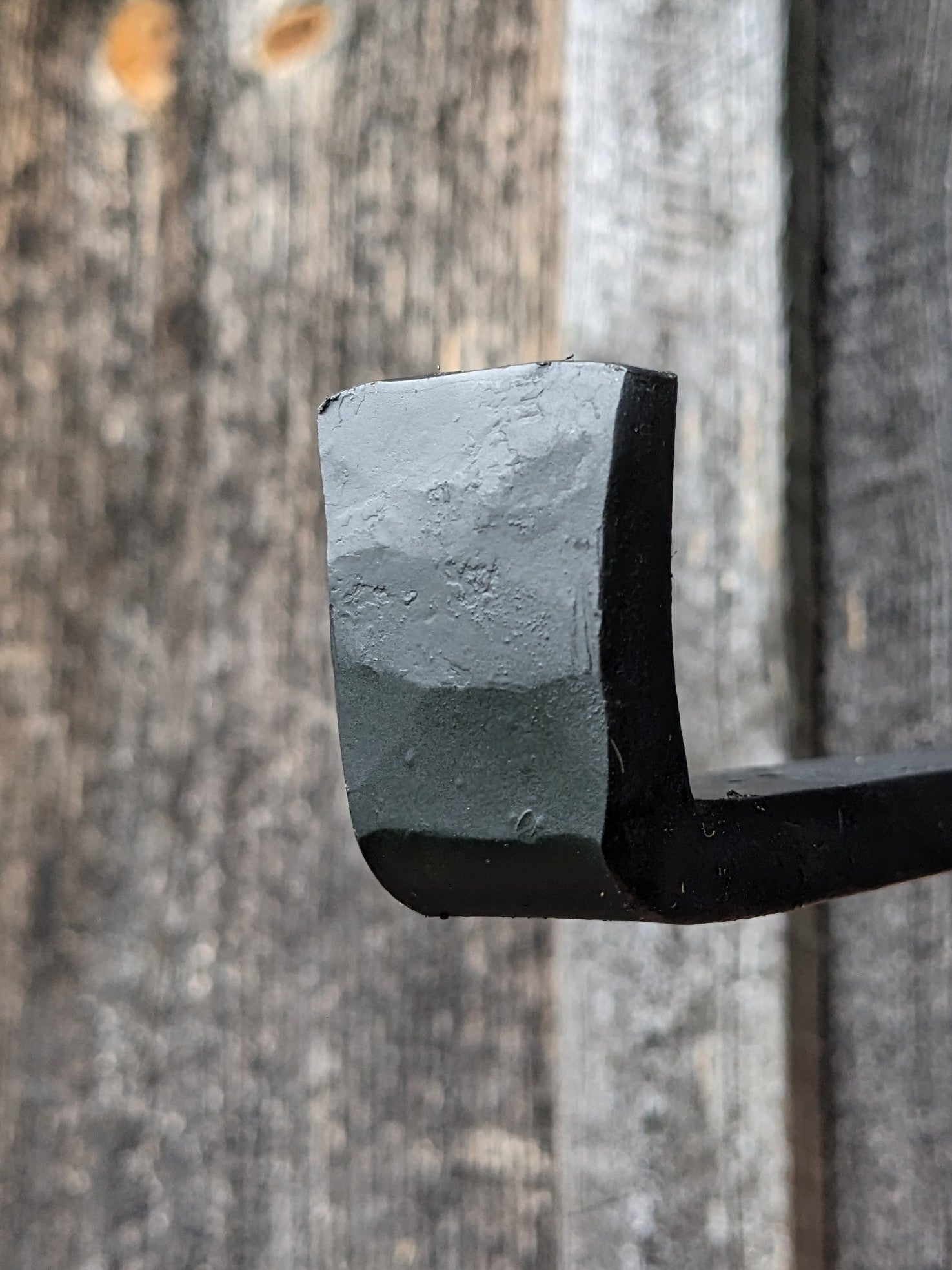 Front edge of hand floating shelf brackets, showing the hand hammered texture.