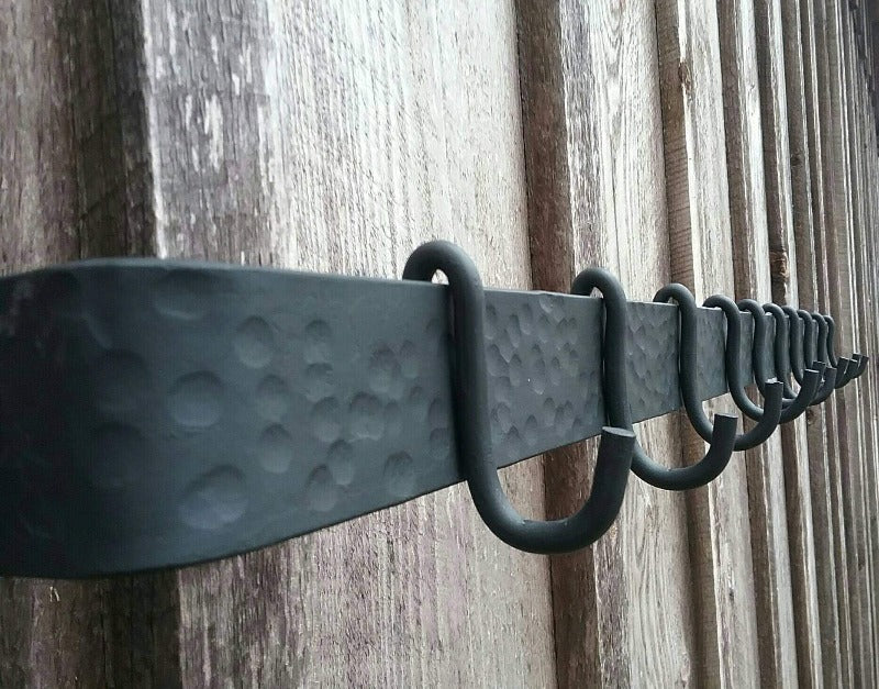 Side view of 48" hand forged hammer finish pot rack.  Shown with 10 standard movable hooks.